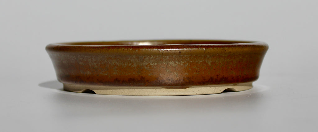 Round bonsai pot in a copper brown/orange glaze. D.133mm
