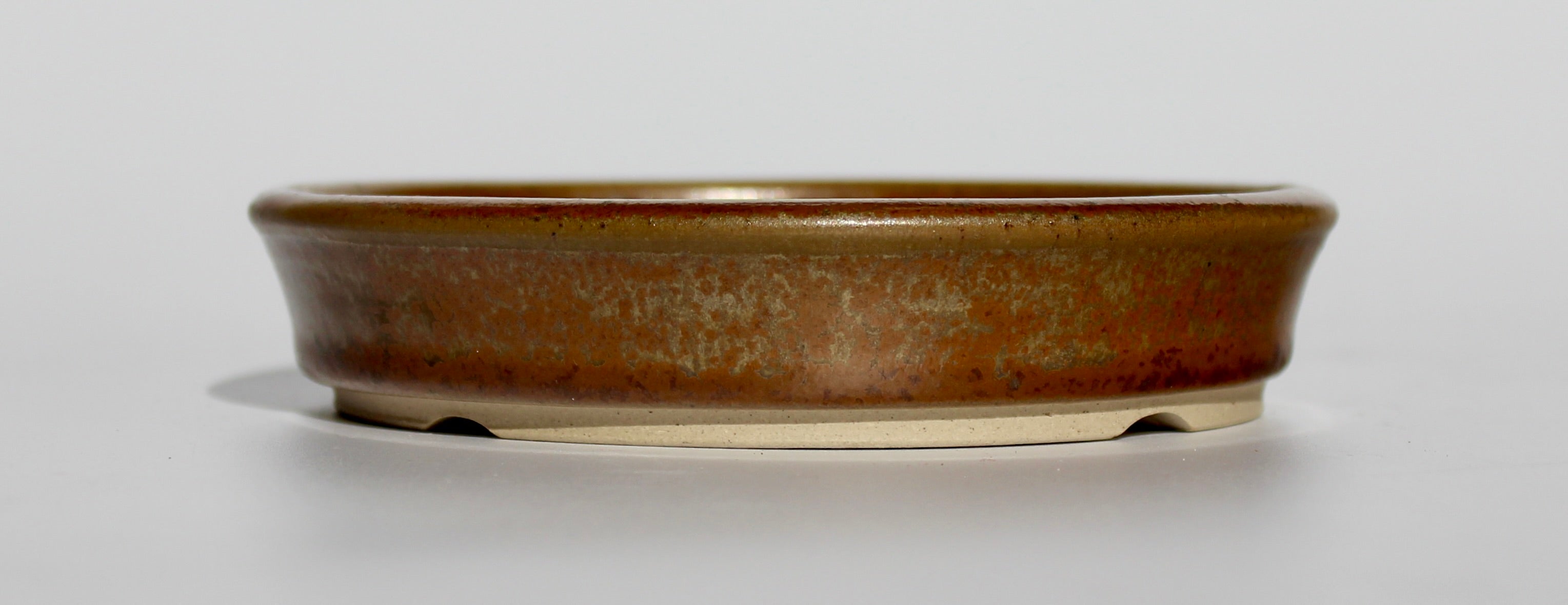 Round bonsai pot in a copper brown/orange glaze. D.133mm