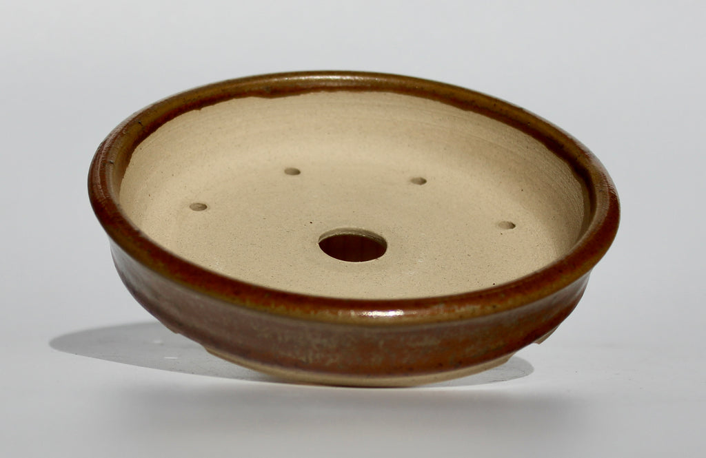 Round bonsai pot in a copper brown/orange glaze. D.133mm