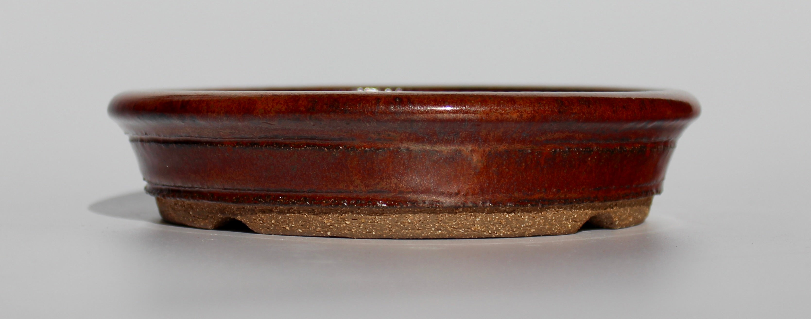Round bonsai pot in an iron red glaze. D.163mm