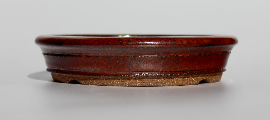 Round bonsai pot in an iron red glaze. D.163mm