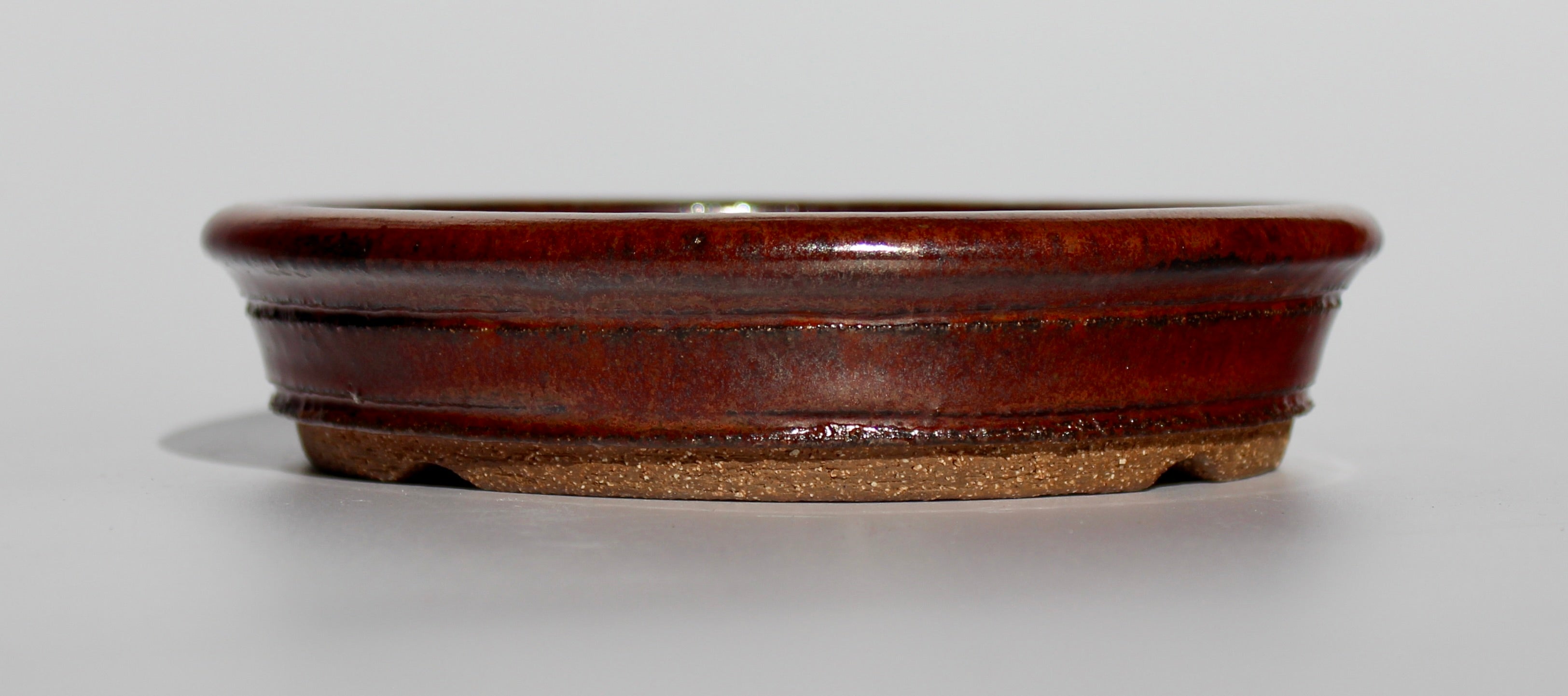 Round bonsai pot in an iron red glaze. D.163mm