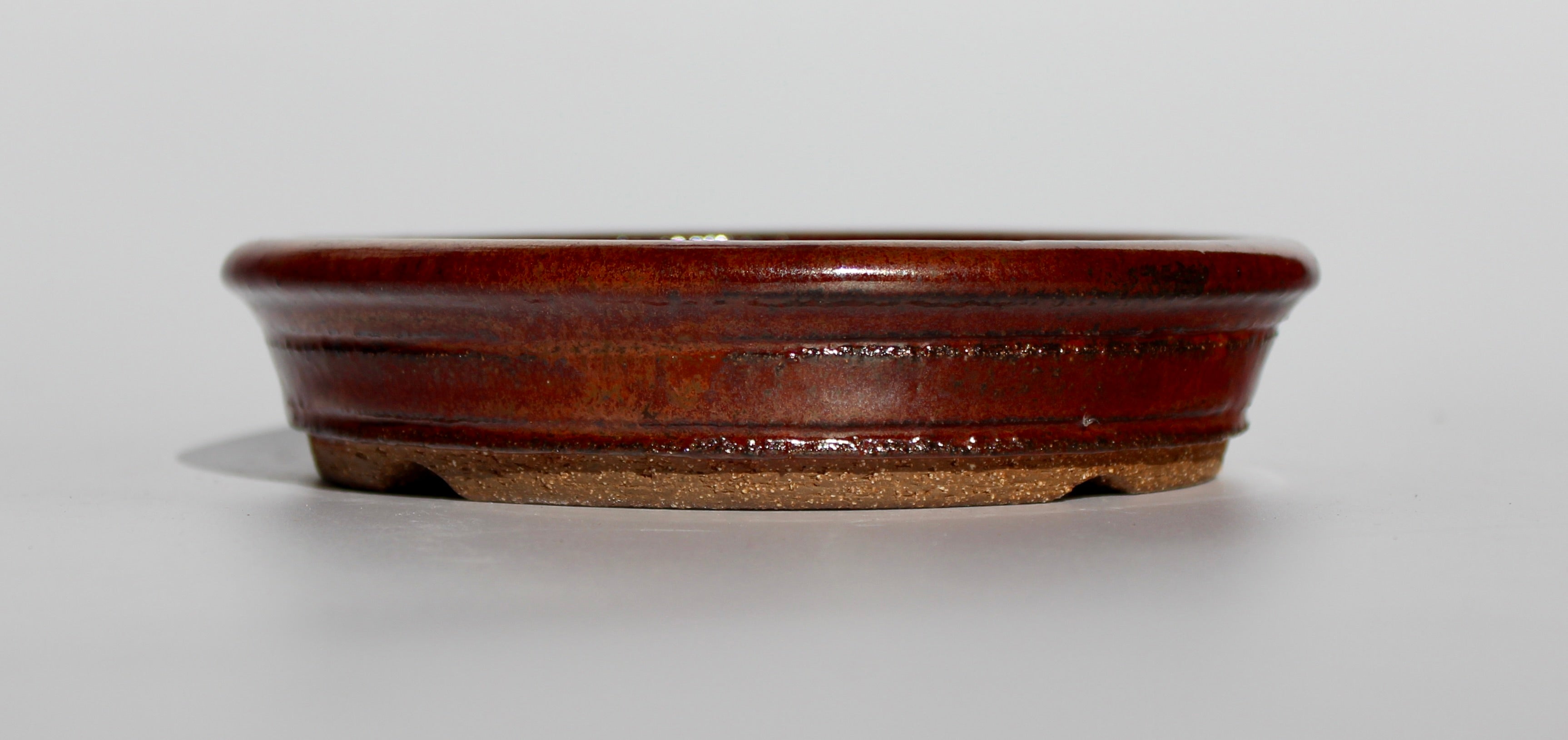 Round bonsai pot in an iron red glaze. D.163mm
