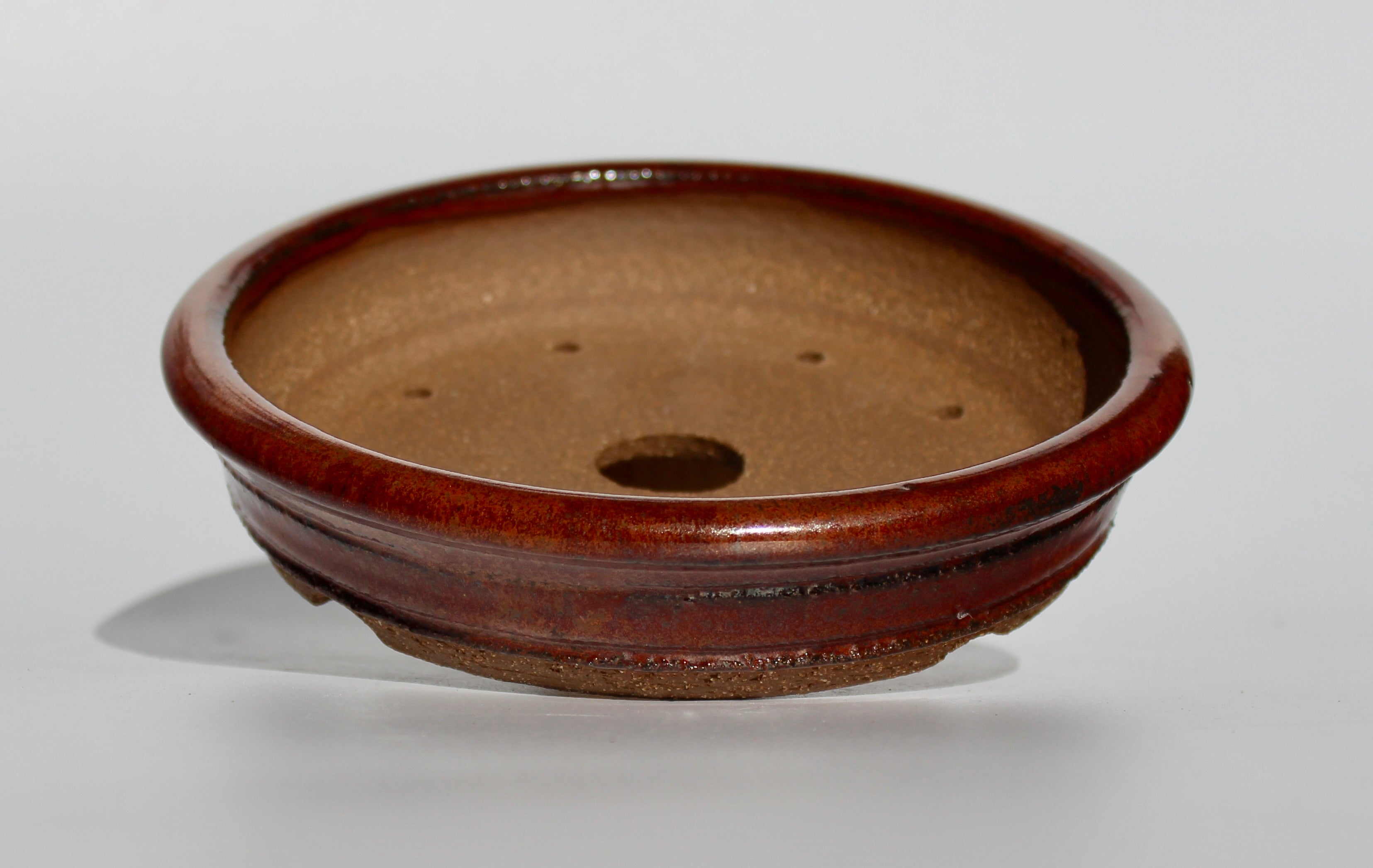 Round bonsai pot in an iron red glaze. D.163mm