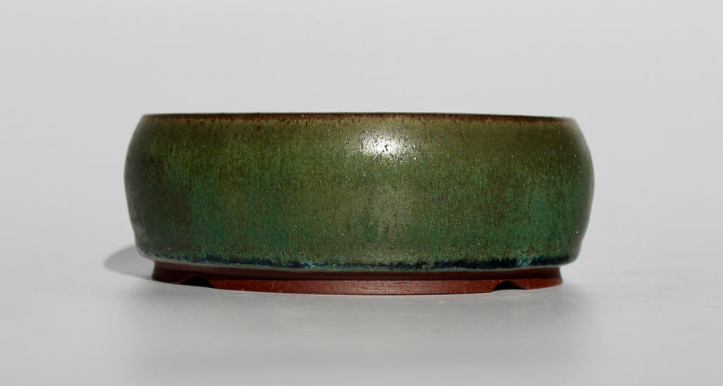 Round bonsai pot in a dark green copper glaze. D.130mm