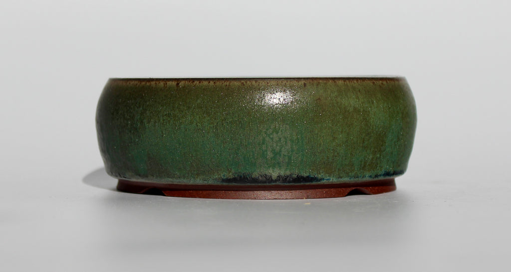 Round bonsai pot in a dark green copper glaze. D.130mm