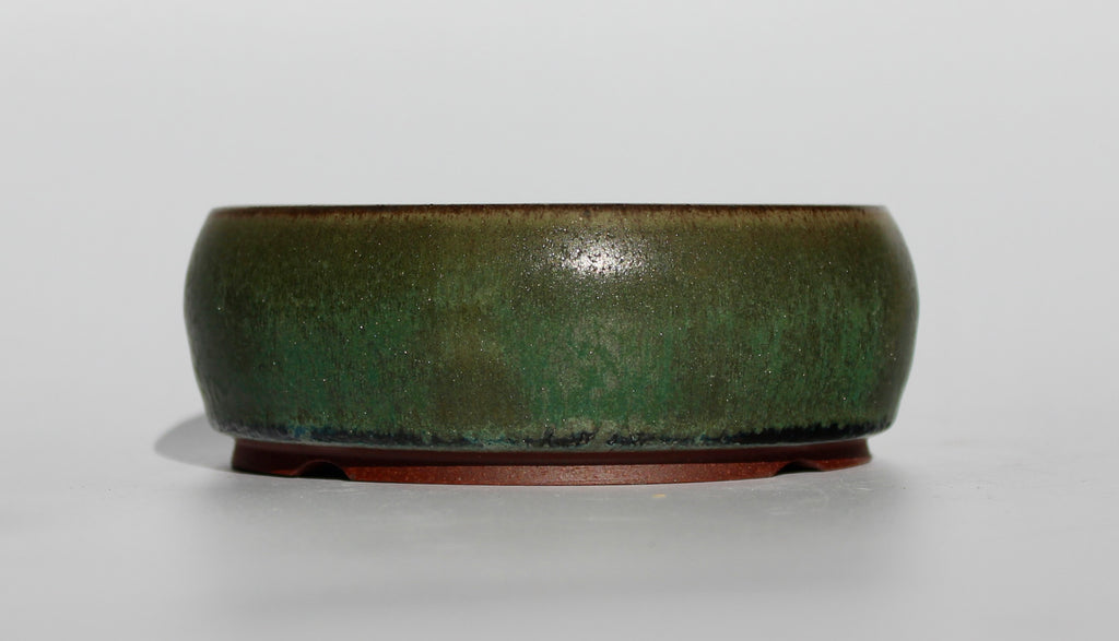 Round bonsai pot in a dark green copper glaze. D.130mm