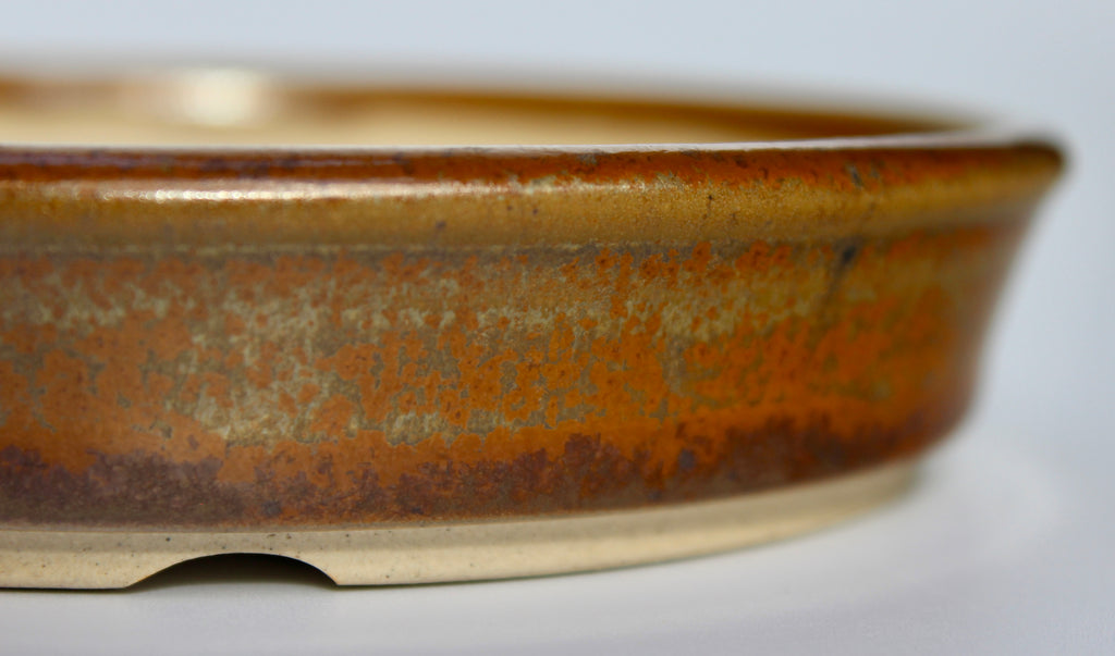 Round bonsai pot in a copper brown/orange glaze. D.133mm